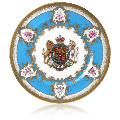 Royal coat of arms English fine bone china dinner plate with gilded rims and featuring a lion and unicorn royal crest surrounded by ornated gold patterns and English flower patterns on a blue coloured background. 