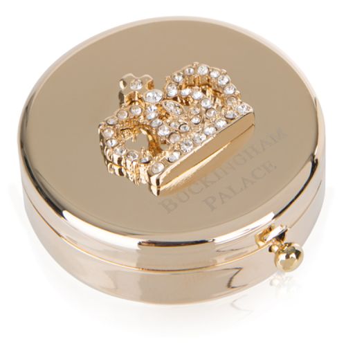 Gold compact mirror with bejewelled crown on top. Buckingham Palace etched below.
