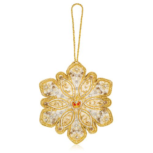gold and silver beads embroidered on a snowflake decoration with a red and gold crown at the centre
