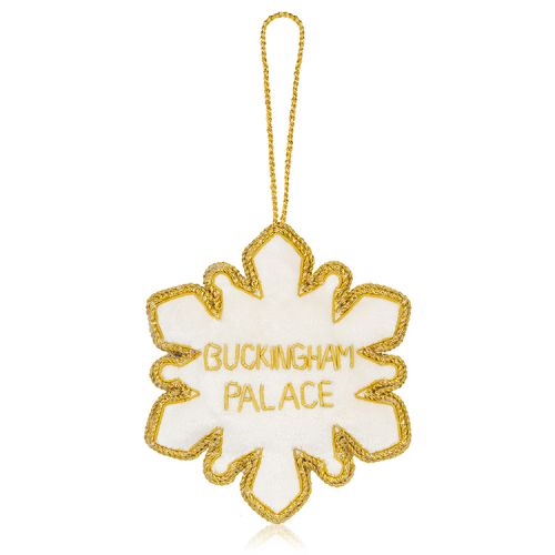 gold and silver beads embroidered on a snowflake decoration with a red and gold crown at the centre