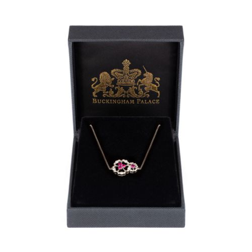 Silver bracelet with two floral details with a pink crystal centre