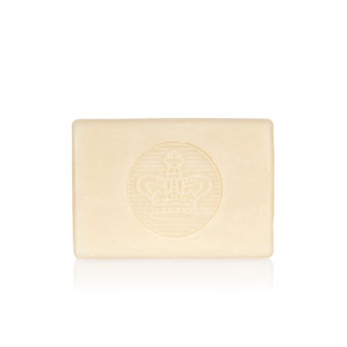 bar of soap wrapped in yellow paper printed with oranges and pears. There is also a gold seal with a crown and a white box saying 'Buckingham Palace Pear and Orange Blossom Premium English Soap Handmade in London'