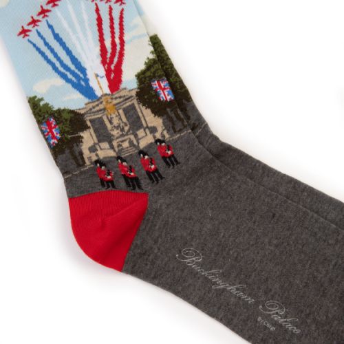 Pair of socks with scene of Buckingham Palace with trooping of the colours above.