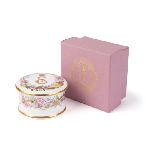 Fine bone china pillbox decorated with Princess Elizabeth's cypher as the central motif. Surrounding the cypher is floral arrangements, cherubs and feathers. Finished with gold leaf. 