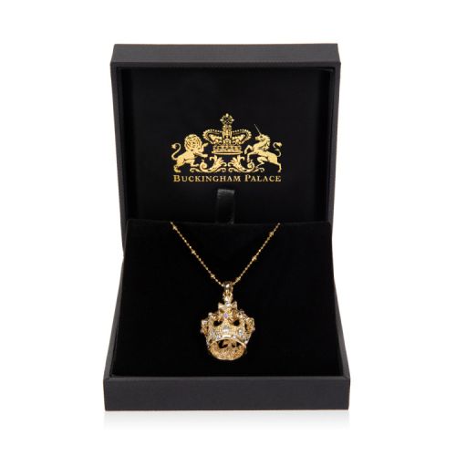 Gold crown pendant with blue crystals and costume pearls on a gold chain.