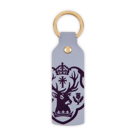 Front of keyring with purple Palace of Holyroodhouse crest against lilac background. Front of keyring with purple Palace of Holyroodhouse crest against lilac background.