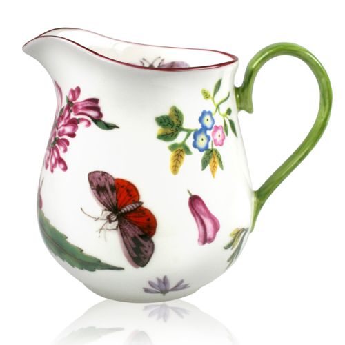 White milk jug with painted flowers and green handle. 