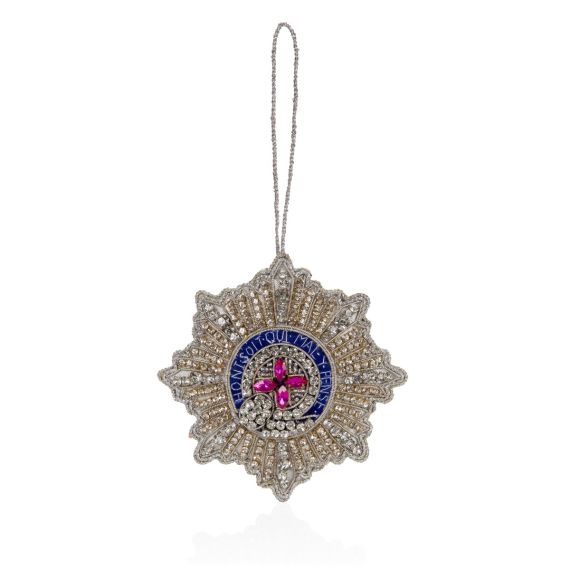 Garter star decoration with hanging string. Crystals, cover the surface, middle crystal cross are pink. Blue with latin text. 