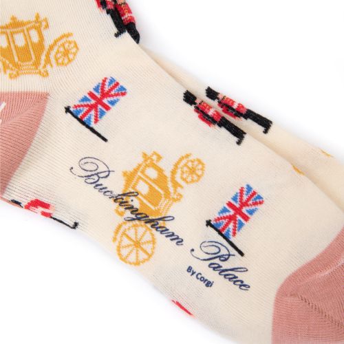 Cream pair of socks with light pink heels and toes. Gold carriage, Guardsman and Union Jack print.