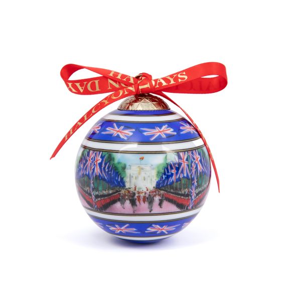 Halcyon Days blue china bauble with red ribbon and Trooping the Colour on the Mall painted on it. Halcyon Days blue china bauble with red ribbon and Trooping the Colour on the Mall painted on it.