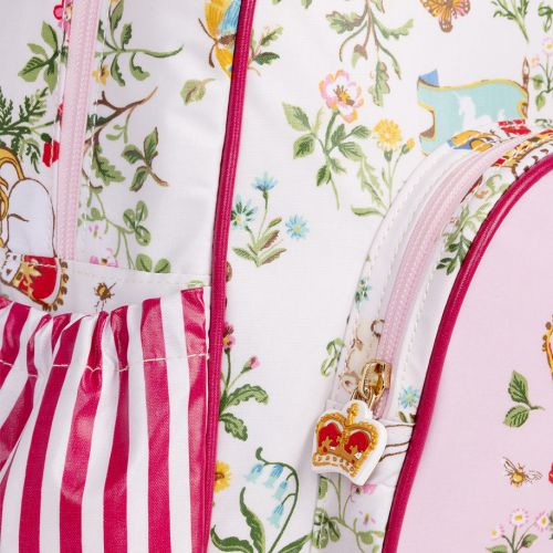 The pink children's backpack, with a floral pattern with a shield, unicorns and crown more with the floral symbols of the four British nations. Pink front pocket with detail of unicorn and royal crown.
