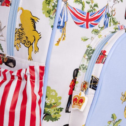 The Children's Royal Guard Backpack, featuring the new designs with Royal Guards marching through the woods trumpeting and drumming, as well lions with the floral symbols of the four British nations and trees. The front pocket is blue and features a lio