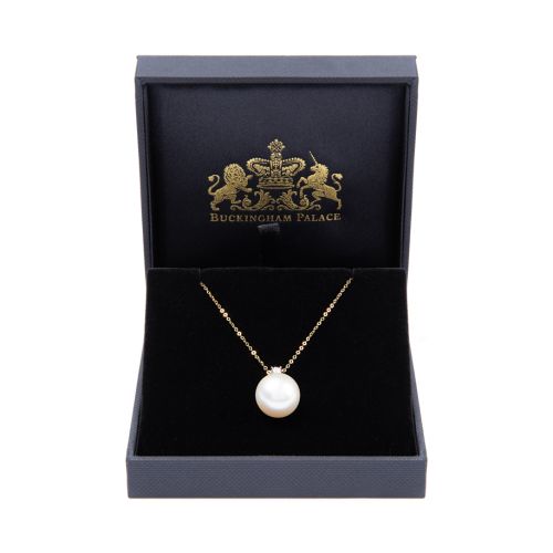 Delicate gold chain with small diamond connected to large South Sea pearl. 