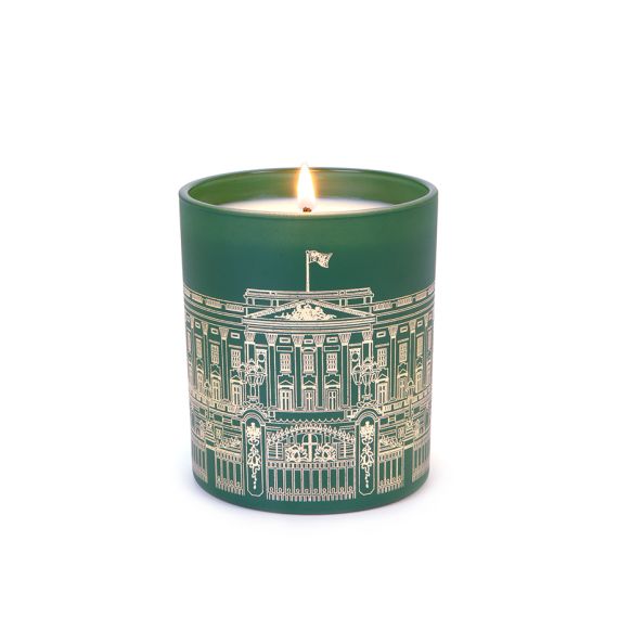 Green lit candle with Buckingham Palace Facade on front. Green lit candle with Buckingham Palace Facade on front.