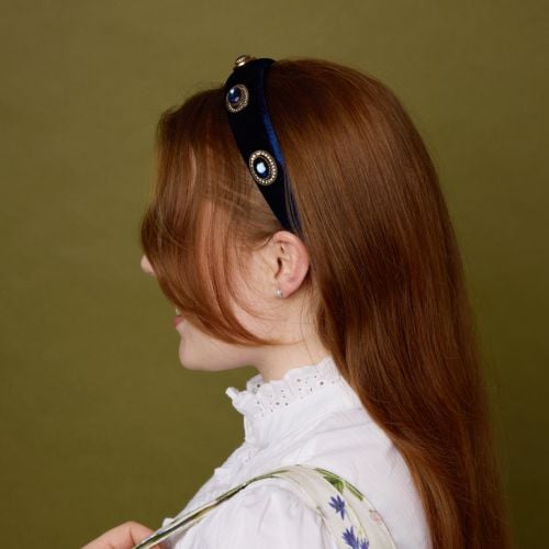 Blue velvet headband on model. 