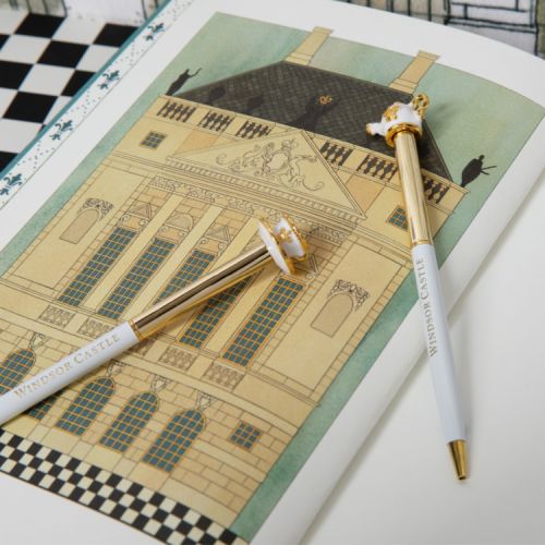 White and gold pen with teacup and saucer topper.